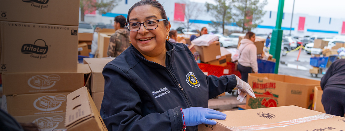 Woman organizes food donations at volunteer event